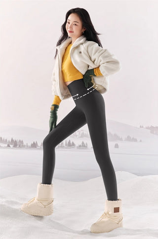 Woman in winter clothing standing in a snowy landscape